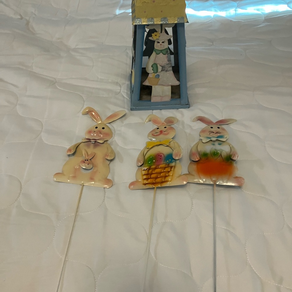 Easter-themed metal bunny rabbit garden stakes and a decorative lantern,